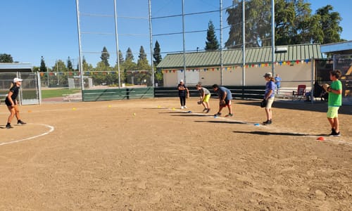 Kids fielding balls on baseball field