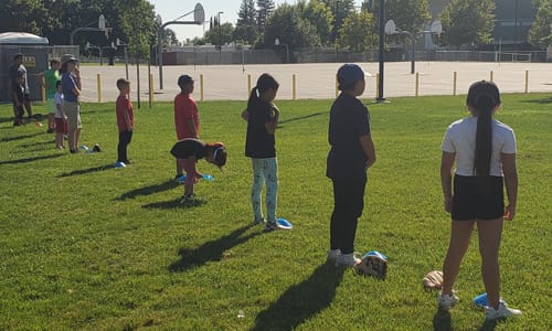 Kids lined up on grass