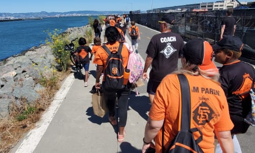 People walking to baseball game