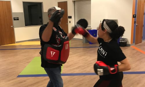 Kid working on punches with instructor