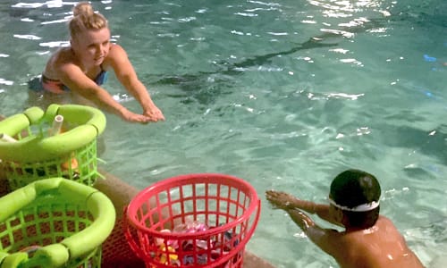 Kid being taught how to swim