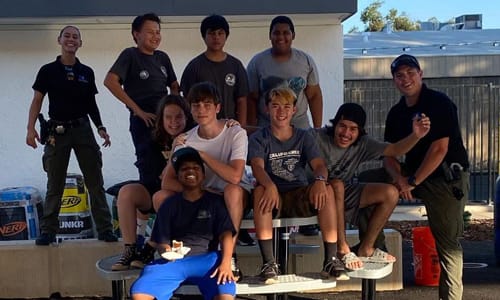 RCPD and group of kids smiling on park bench