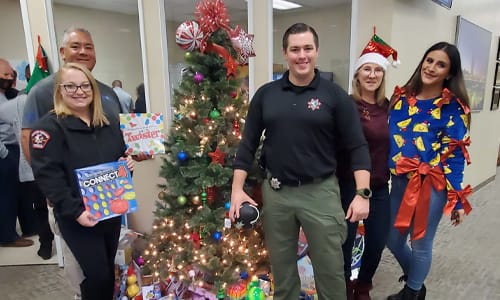 Volunteers, Batman and an elf at Christmas in Cordova